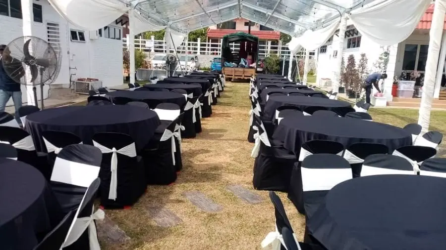 Clear canopy setup with black round tables and matching chairs