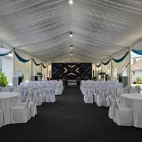 Marquee round table setup with white covered chairs