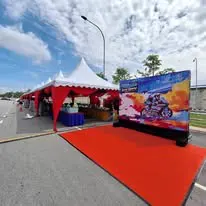 Outdoor canopy entrance with red carpet and event setup