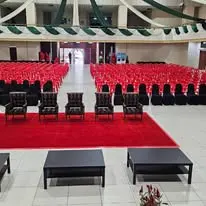 Hall event with red chairs VIP seating and sofa tables