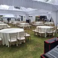 Round table and Chiavari chair setup under canopy