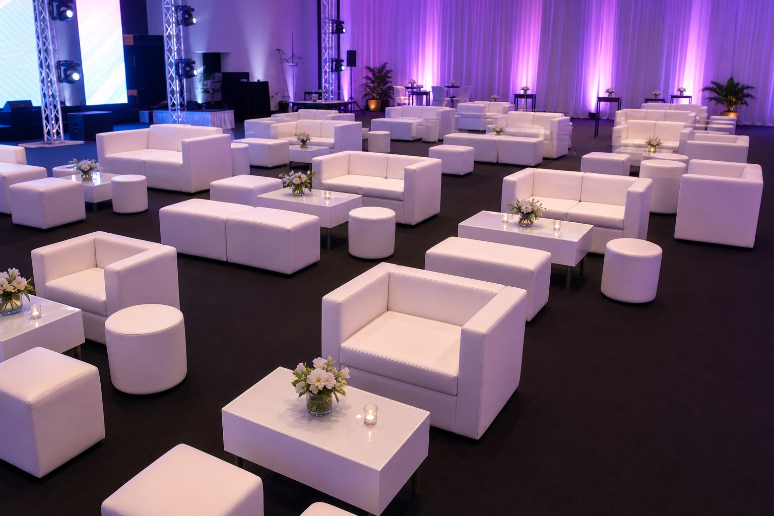 White cube sofa and ottoman lounge sets arranged for indoor event reception